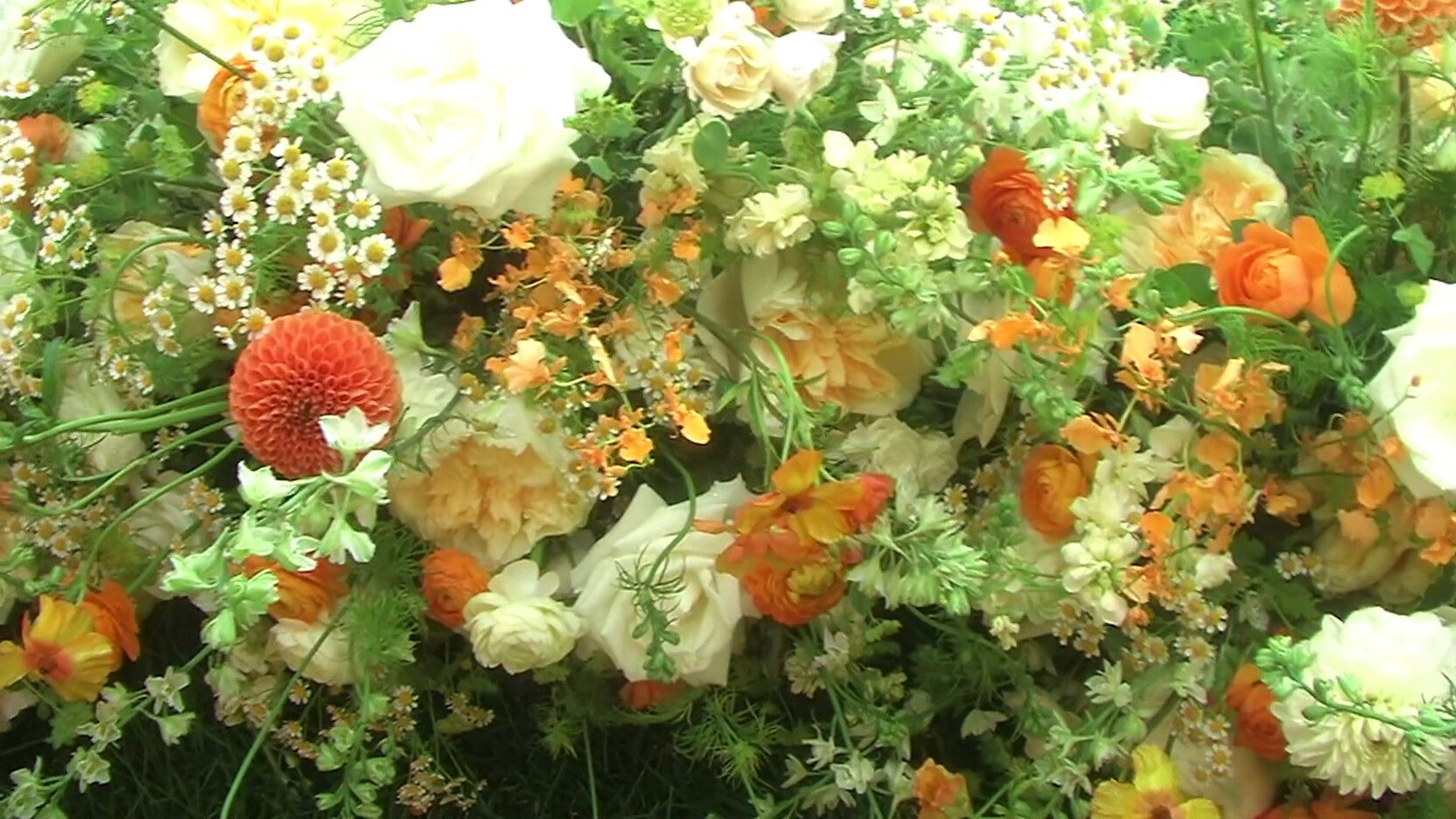 Orange and cream wedding florals showing JVC 3CCD color depth on a vintage camcorder rental