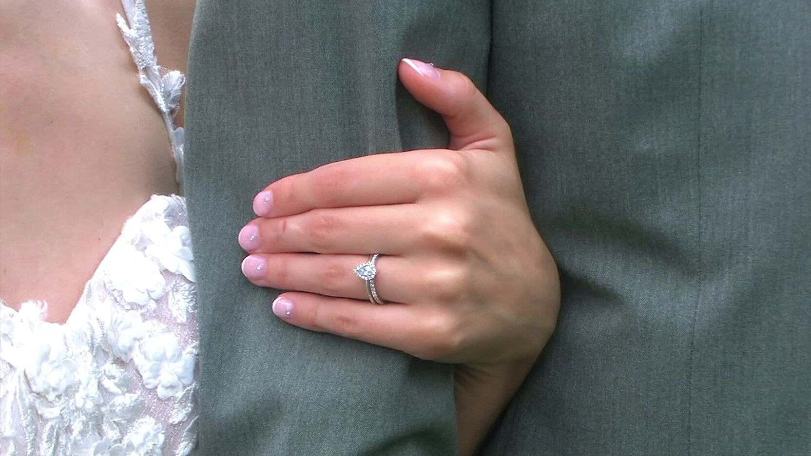 Wedding ring detail on a sage green suit sleeve, filmed on a JVC 3CCD vintage camcorder